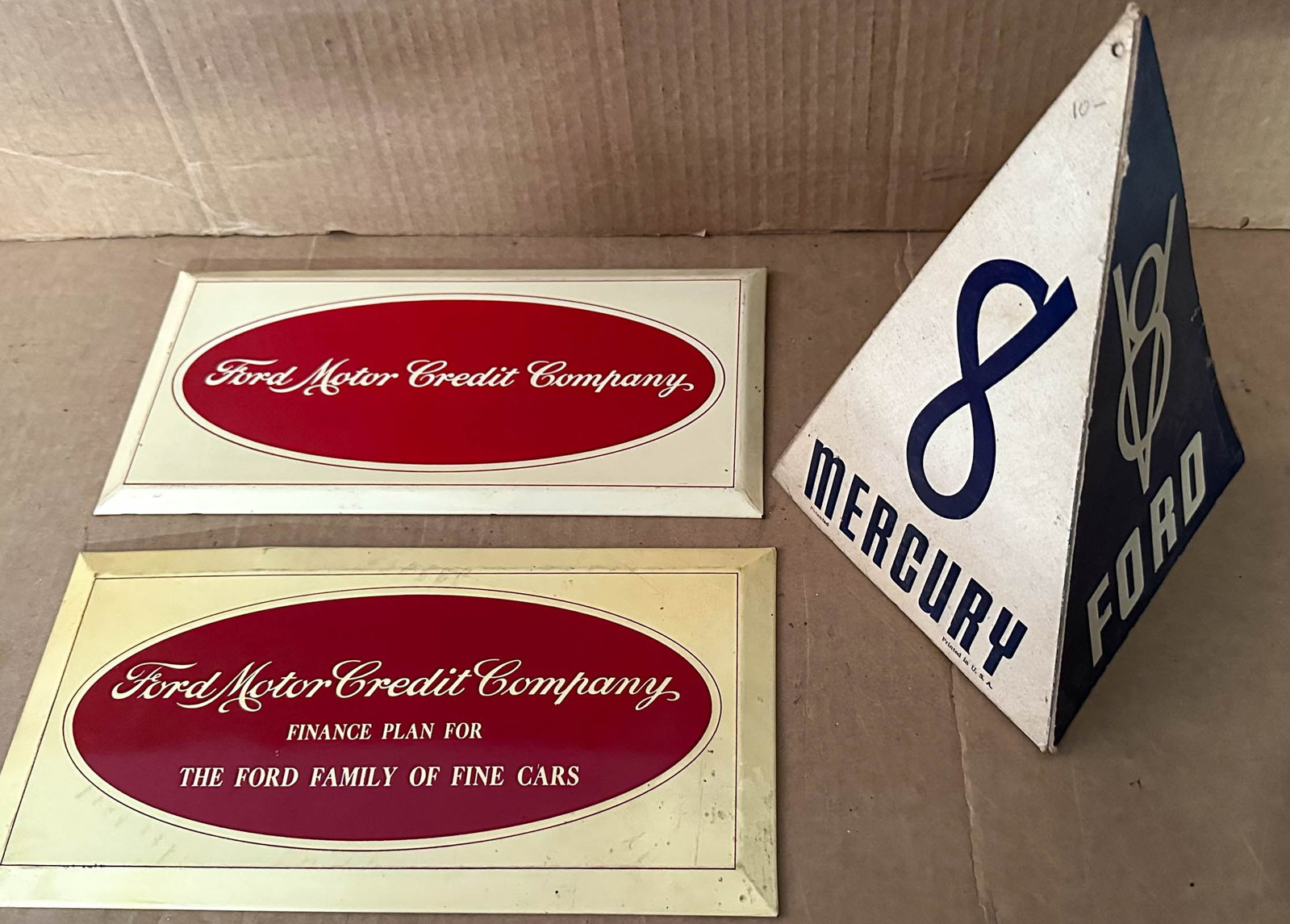Counter Displays: Three Ford counter displays, late 1930's - early 1940's, two different Ford Motor Credit Co, crimped face over cardboard cut out stand, 6 x 12 each and Ford Mercury, pyramid stand, 7 base x 10 high.