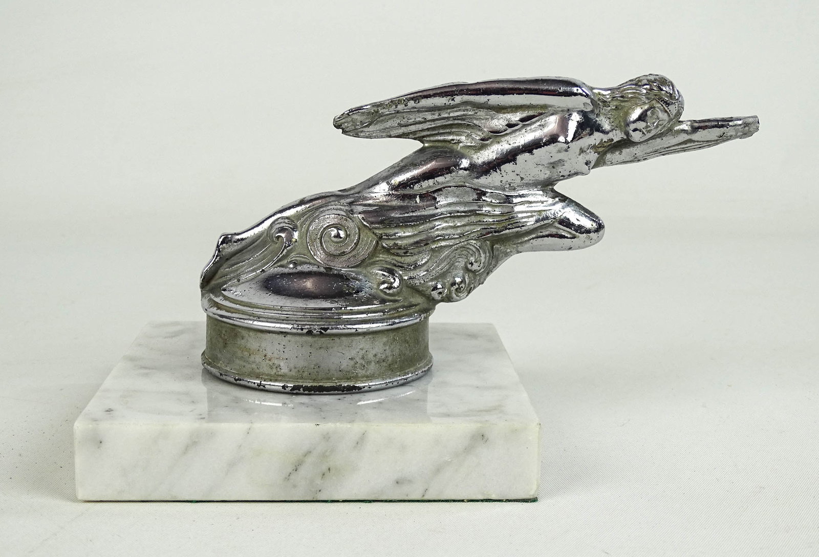 Vintage Studebaker Hood Ornament: Vintage Studebaker Atlanta "Flying Goddess" hood ornament on marble base. Tip of hand repaired. 4" Ht..