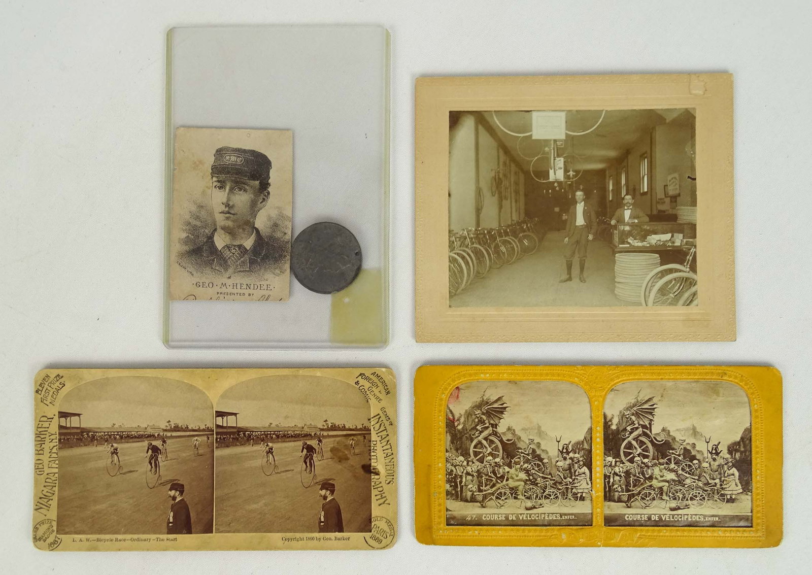 Stereo Cards: 2 stereo cards (1 of boneshakers "Bicycle Race in Hell" - 1 of a high wheel race Buffalo or Niagara Fall N.Y.), bicycle tournament token 1884, bike shop photo late 1890's. (4 items). Good condition.