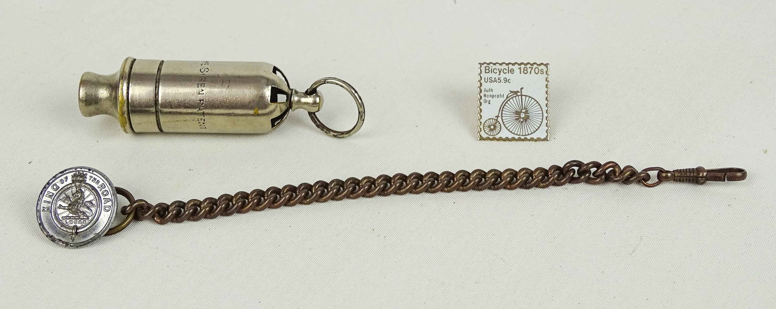 The Acme Siren: The Acme Siren - late 1890's early 1900's - work fine - high wheel tie pin - Lucas watch fob. Good condition. Glenn Eames Collection Burlington Vermont.