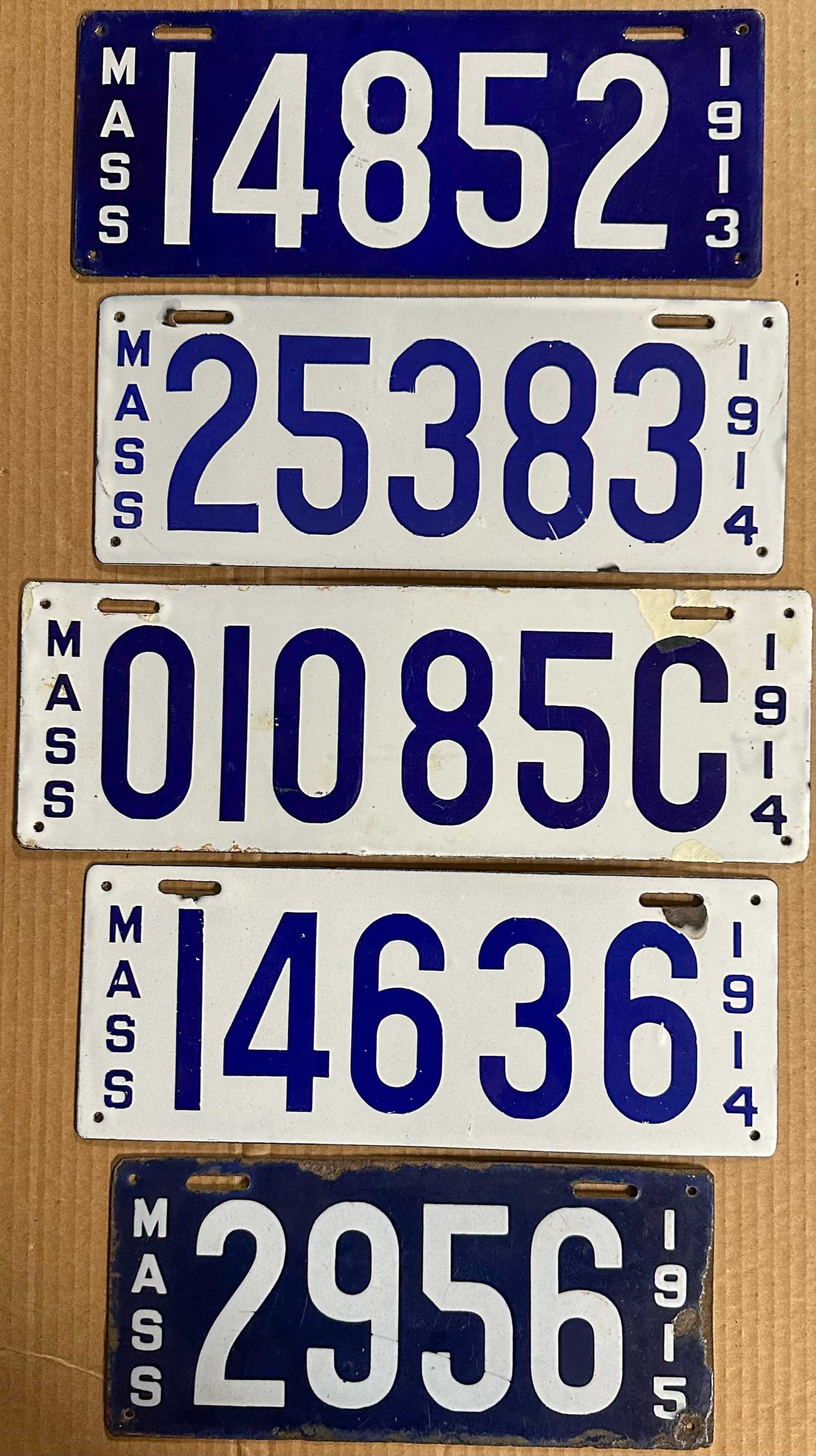 License Plates: Five Massachusetts porcelain license plates, 1913, two different 1914, 1915, 1914 dealer (touched up on right side).