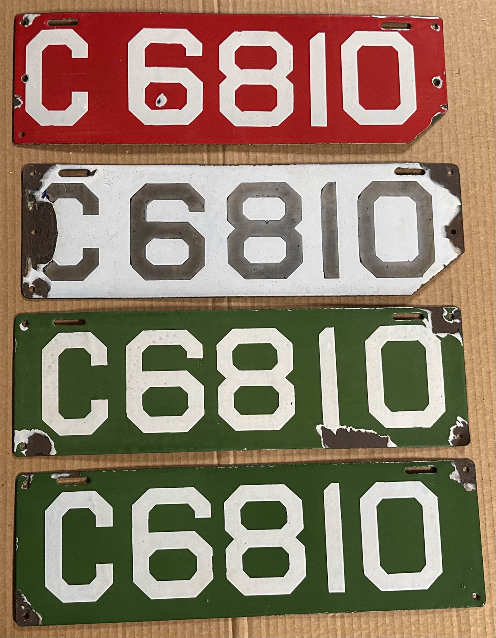License Plates: Four Connecticut #6810 porcelain license plates, 1910 red and 1911 white with lower right corner cut and a pair of 1912 green with white digits.