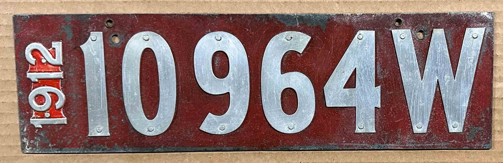 License Plate: 1912 Wisconsin license plate, riveted digits , date and W.