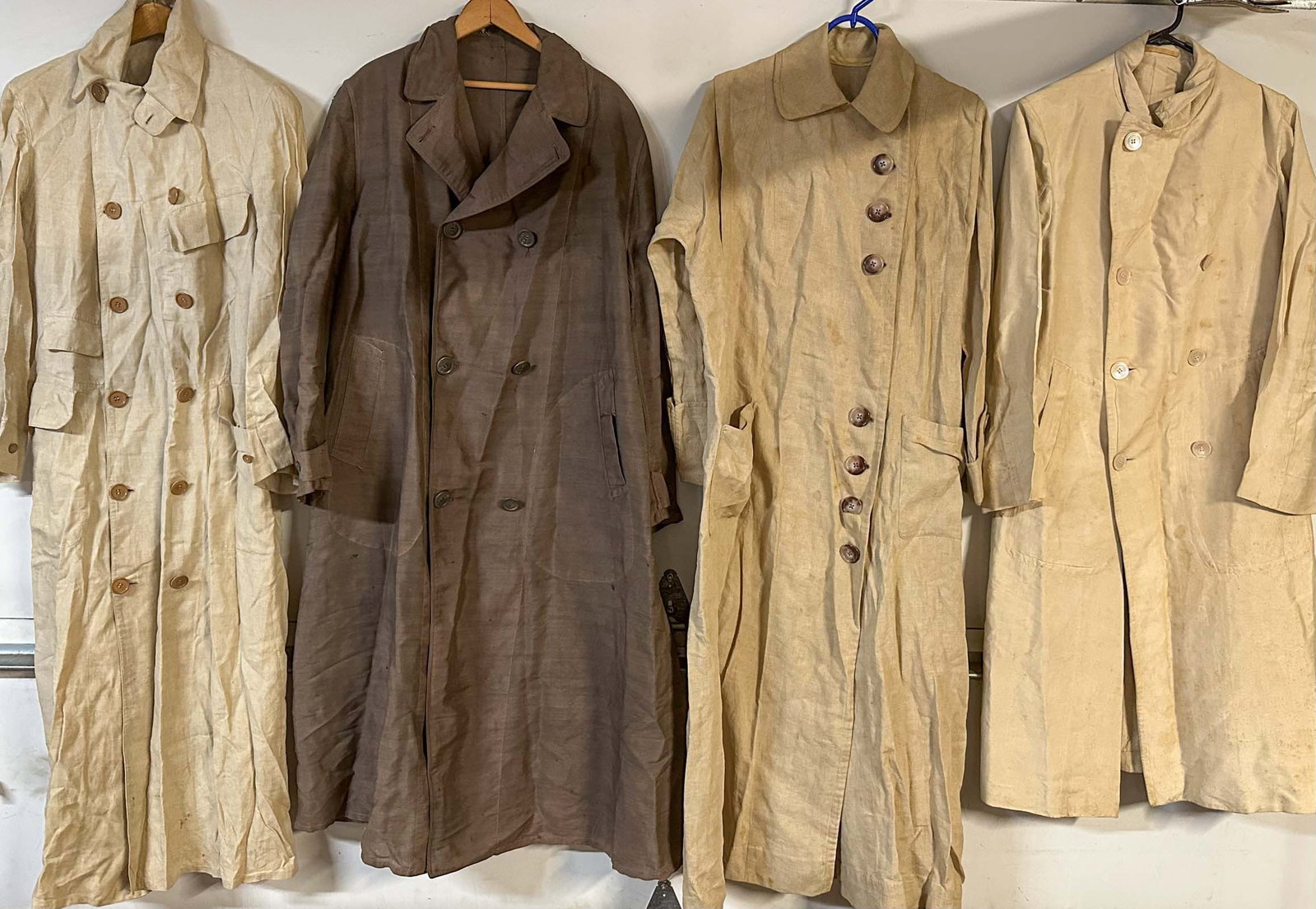 Misc. Lot: Four different brass era auto dusters, three beige and one brown.