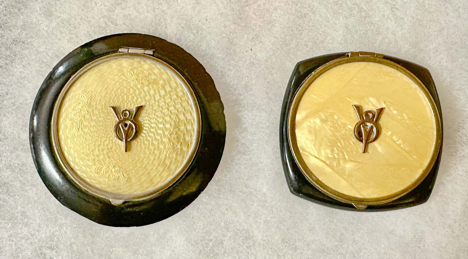 Ladies Compacts: Two ladies compacts with Ford V 8 logo attached, each opens, descriptive brochure copy included, round 3 inch dia, square 2.5 x 2.5.