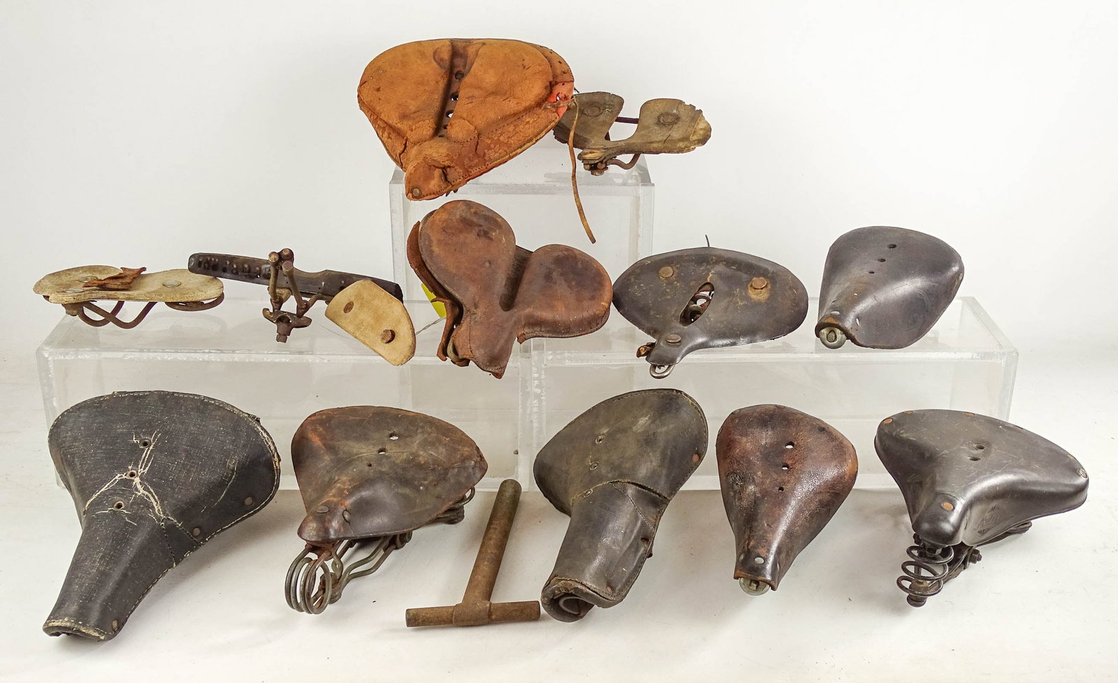 Saddles Hardware Box: Misc box lot of saddles and saddle hardware - 2 T.O. Co. seats and 1930's saddles. Glenn Eames Collection Burlington Vermont.
