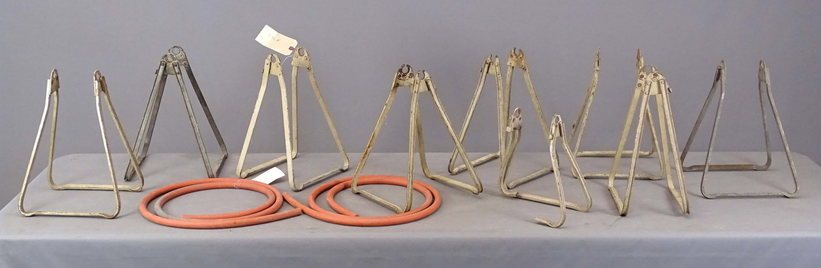 Bicycle Stands: Lot of early vintage bicycle stands. Along with rubber tire.