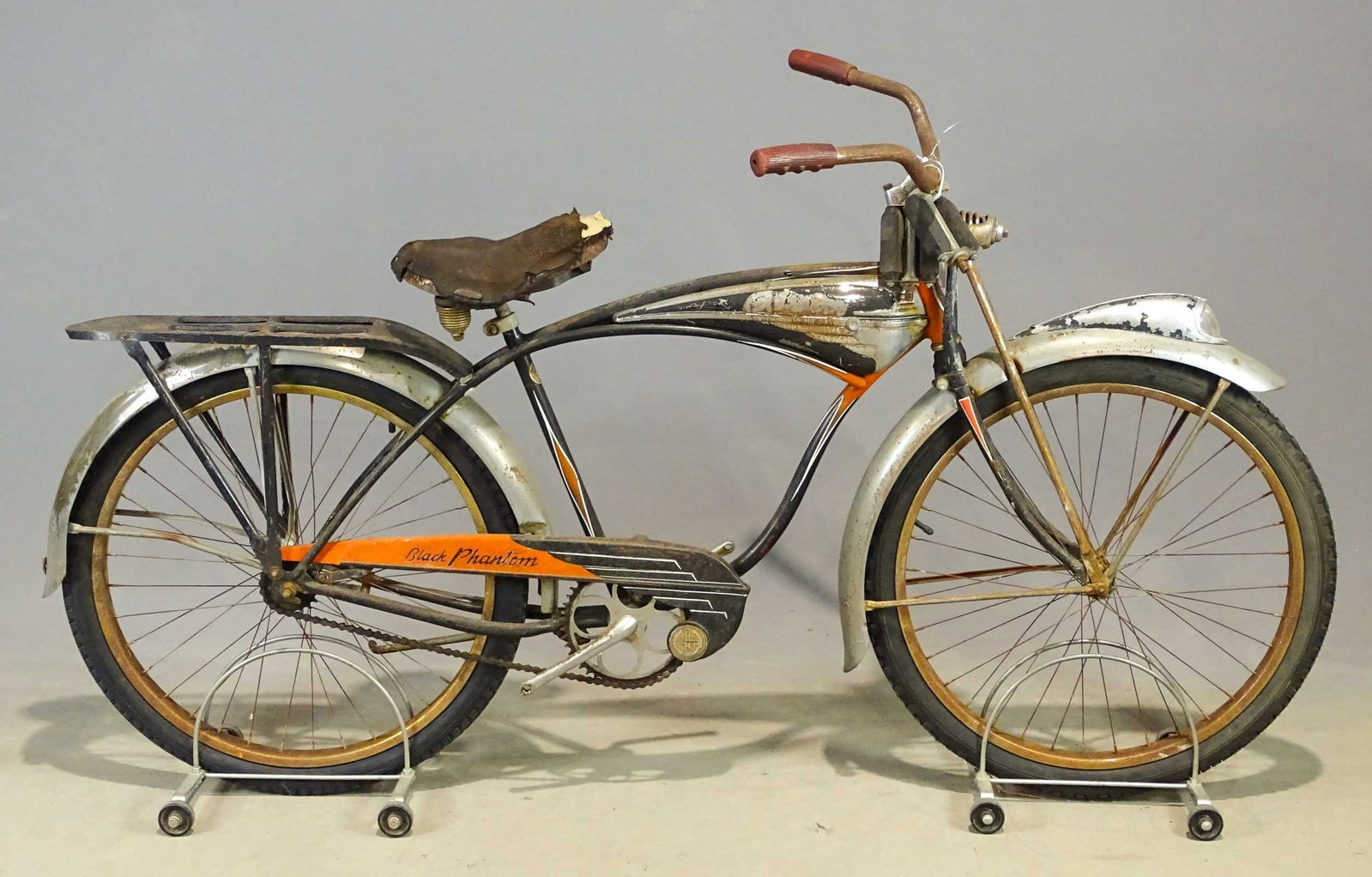 Schwinn Black Phantom Bicycle: 1954 Schwinn Black Phantom bicycle. Serial #N87578, horn tank, locking spring fork, headlight, 4-hole rack, leather seat. As found.