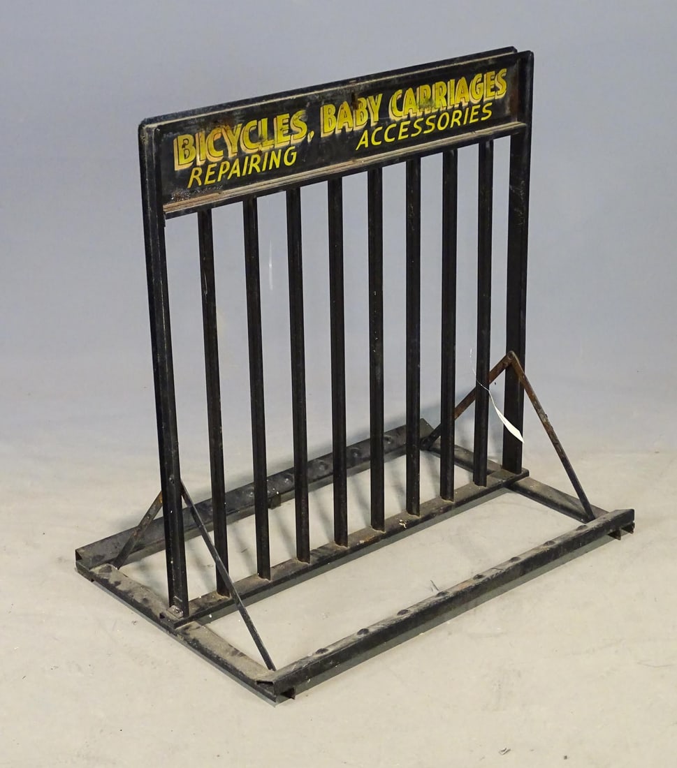 Bicycle Stand: Early metal bicycle stand marked "BICYCLES, BABY, CARRIAGES / REPAIRING / ACCESSORIES". 36" x 24" x 36". Good condition.