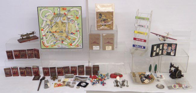 Misc. Lot: Misc. table lot including tobacco tins, Eddie Cantor gameboard, decorative spoons, gum display, buttons, pinbacks, baseball tokens 1869-1969 Centennial Series", Lady Liberty $1.00 keychain, baseball c
