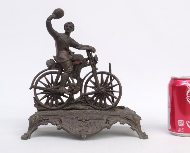 Statue: Man On Safety Bicycle: Metal statue mand on safety bicycle. 9 1/2 length, 11" Ht., hand has crack."