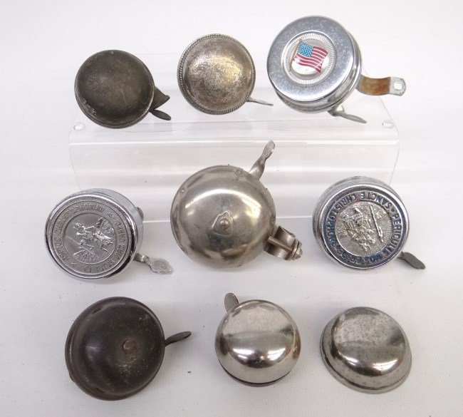 Bicycle Bell Lot: Lot of (8) complete bicycle bells and (1) bell top including (2) St. Christopher bells and (1) flag. Good - fair condition.