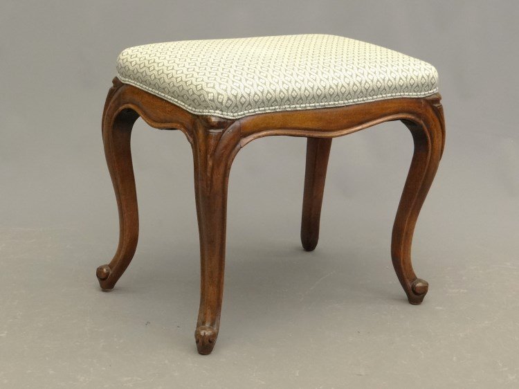 French Footstool: French carved and upholstered footstool. 21 x 15" x 19"."