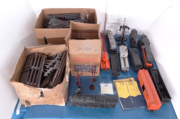 Lionel Train Lot: Lionel trains including #681 locomotive, #2046 W 50 coal tender, #2338 locomotive, #6460 crane car, #22000 coal car, #6464 box car, #6419 caboose, #6012 coal car, tanker, #3927, #6511 flat car, type K