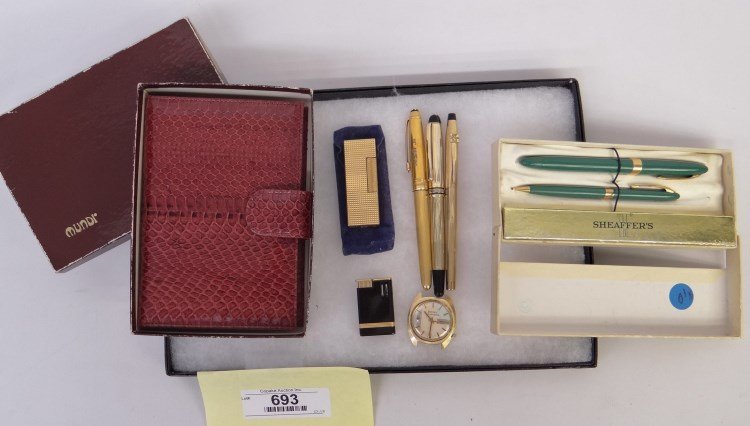 Assorted Lot: Lot including a snakeskin memo book, Dunhill lighter, Sheaffer pen and pencil set, Bulova watch face, McGraw Hill Cross pen, and (2) Mont Blanc Meisterstuck pens.