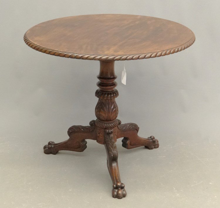 Carved Mahogany Table: Empire style mahogany tilt top table. Loss to one foot. Top 32 diameter, 27 1/2" Ht."