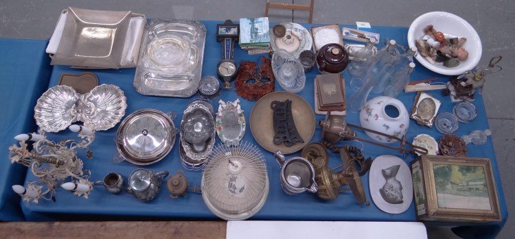 Misc. Table Lot: Misc. table lot including silverplate, vintage New Haven wall clock, lighting, biscuit tin, bottls, books, stoneware etc.