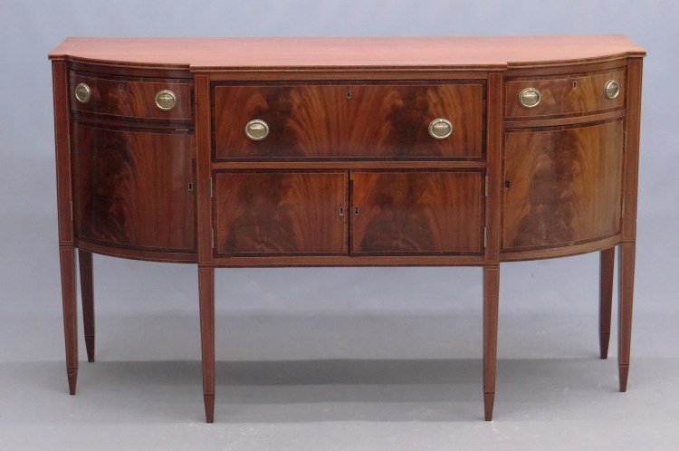 19th c. Federal Sideboard: 19th c. Federal mahogany inlaid sideboard having central long drawer with two doors flanked by side drawers and doors. Center drawer has butlers desk. Tapered legs. 68" x 25 1/2" x 41 1/2".