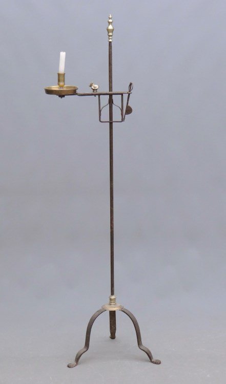 Lighting Device: Floor standard lighting device with brass candleholder, brass finial, brass animal, brass ring above penny feet. 52" Ht.