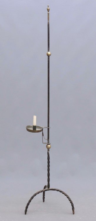 Lighting Device: Wrought iron floor standard lighting device with brass candleholder and brass balls. Tripod base. 59" Ht.