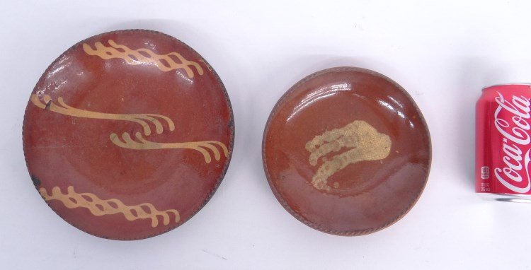 Redware Lot: Lot two early redware slip decorated plates including 7" diameter and 9" diameter (as found).