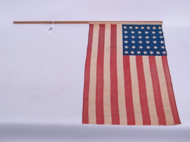 American Flag: Rare 38 star Centennial 1876 American flag, Colorado admitted to the Union. With original pole standard. Flag 24" x 15 1/2", 33" length.