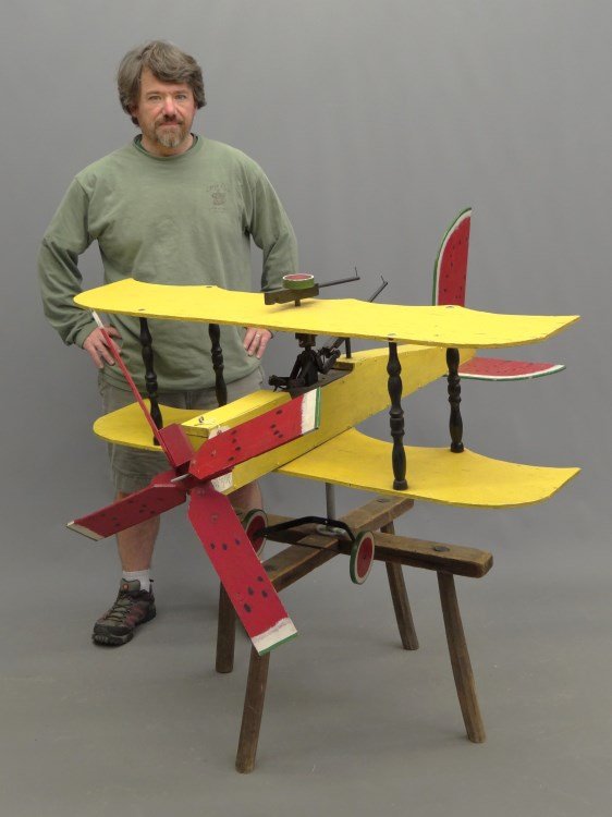 Whirligig Joe McFall: Polychrome painted airplane whirligig by Joe McFall (American 20th c.). 48" wing span, 52" deep.