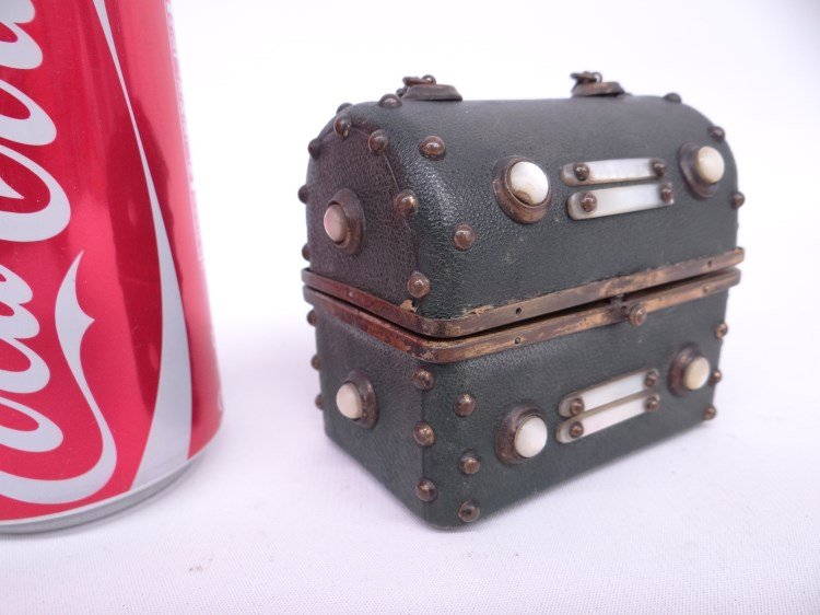 Perfume Set: C. 1900's Continental trunk form case with perfume set. Decorated with MOP. Tops of perfume jars have litho with Continental scence. Case 3 1/2" W, 3" Ht.