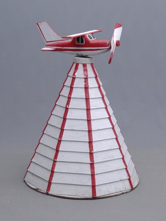 Airplane Whirligig: Vintage painted wooden airplane whirligig on pyramid shaped base. 43 Ht."