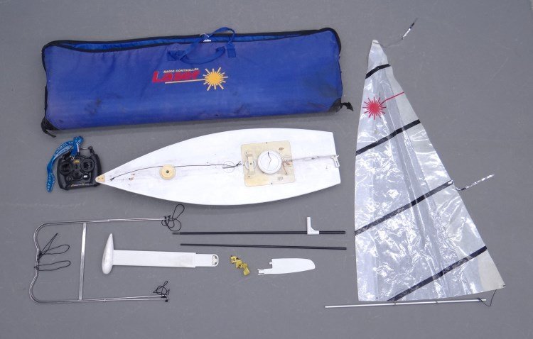 Radio Controlled Pond Boat: Radio controlled pond boat in original bag marked Radio Controlled Laser". Bag 51" length."