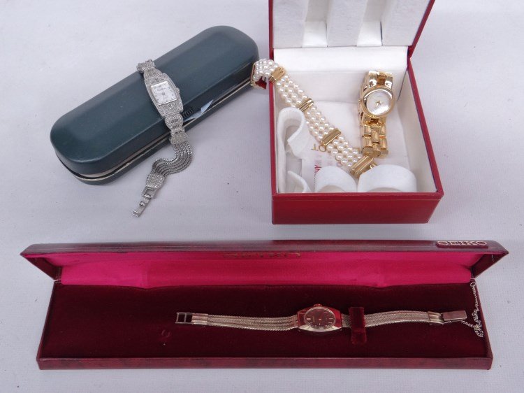 Wrist Watch Lot (3): Lot of (3) wrist watches including: Seiko in orig. box, Peugeot in orig. box (with 2 straps) and Peirre Nicol with marcasite band.