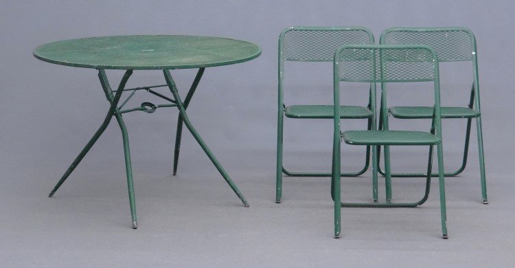 Wrought Iron Table And Chairs: Wrought iron patio table with three chairs. Table 42 diameter."