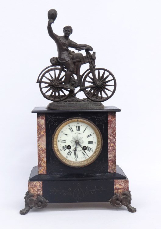 19th c. French Figural Clock: 19th c. French figural slate body mantle clock with triumphant safety rider. Works marked Holsen Paris 7050" 19 1/4" Ht. Porcelain face signed LeGrand Mis St. Loup". Base loose, good as described cond