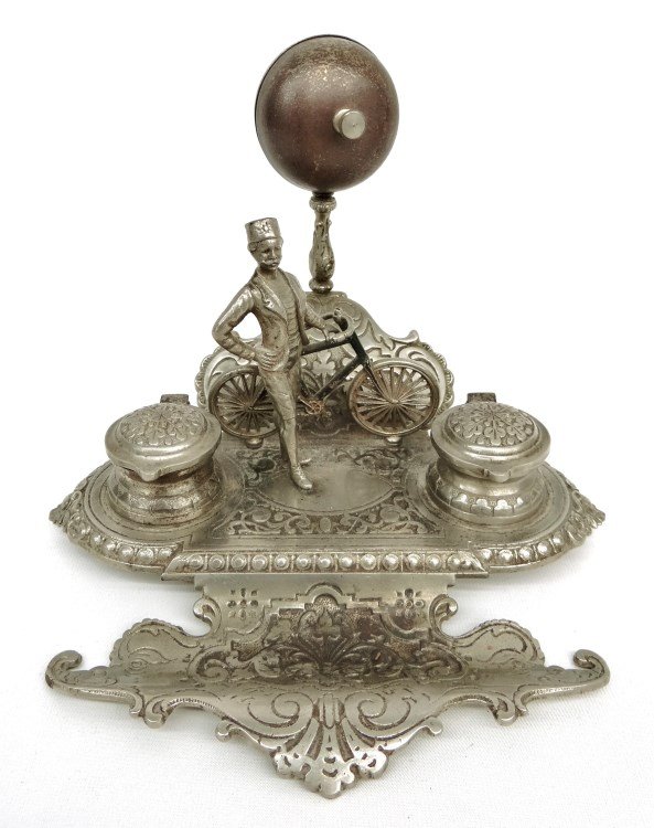 19th c. Figural Desk Set: Rare 19th c. figural nickel plated desk set having bell, uniformed club rider with safety bicycle and pair of ink wells (one glass incert missing). 7 1/2 Ht., 10" x 10" base. Good condition."