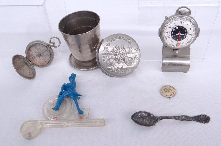 Misc. Bicycle Related Lot: Misc. bicycle related lot including collapsing cup, Orient souvenir spoon, compass, League Of American Wheelmen pinback etc., fair to good condition. David Metz Museum.