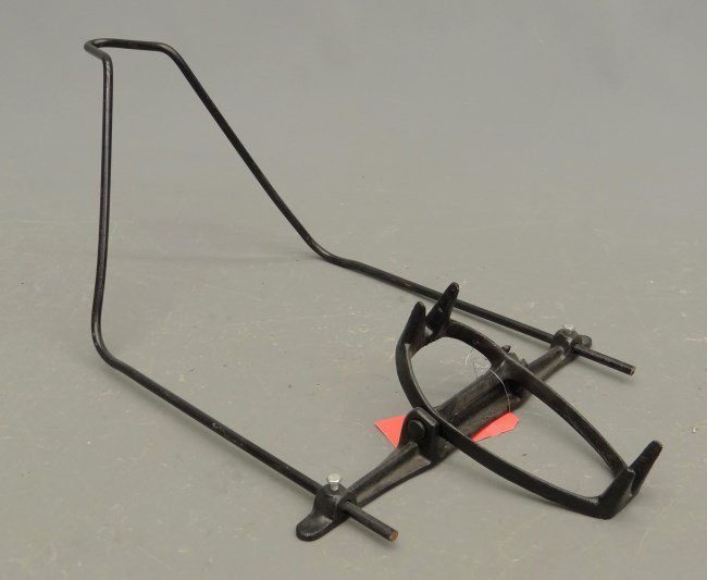 Bicycle Stand: Reproduction iron bear trap type bicycle stand. Pedaling History Museum.
