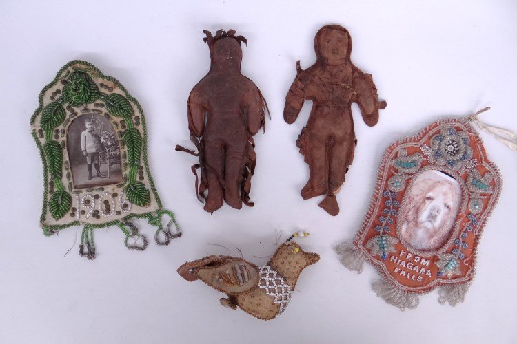 Beadwork Frames & Leather Dolls: Lot including two early leather dolls, beadwork bird and two beadwork frames.