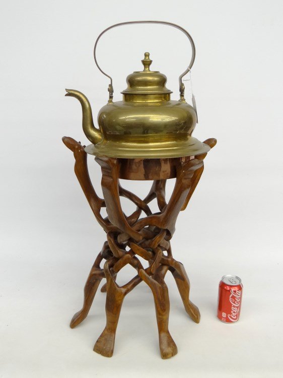 Brass Kettle: African brass and copper kettle on carved puzzle stand. 25" Ht.