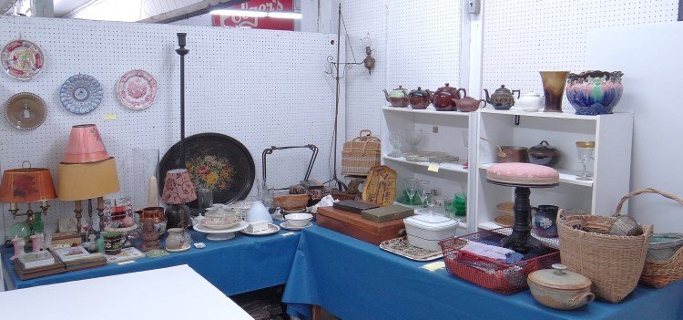 Misc. Lot: Misc. lot including piano stool, Depression glass, pottery, teapots, baskets, flatware, primitives, lamps, Tiffany candlesticks (as is), over 100 objects.