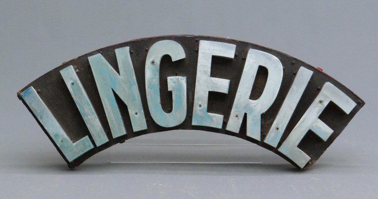 Trade Sign: C. 1930's arched "LINGERIE" metal trade sign in blue paint. 36" W, 10" Ht.