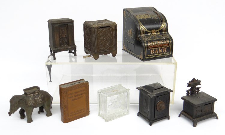 Bank Lot: Lot eight misc. banks including cash registers, elephant (missing tusk), safe, stove, radio, glass block.