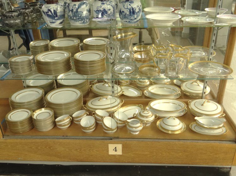 French Porcelain Dinner Service: French porcelain dinner service with gold banding includes (12) 9 1/2" plates, (11) 8 1/2" plates, (12) 7 1/2" plates, (12) 6 1/4" plates, (12) 5" deep saucers, (12) 9" soups, (12) cups saucers, cream