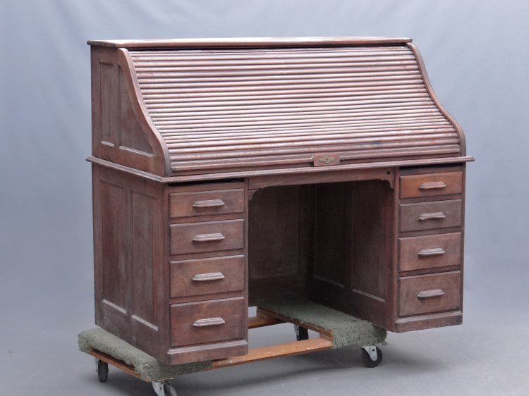 Oak Rolltop Desk: C. 1900's oak rolltop eight drawer desk. Has cubby interior. 59 1/2" x 32" x 50 1/4". As found.
