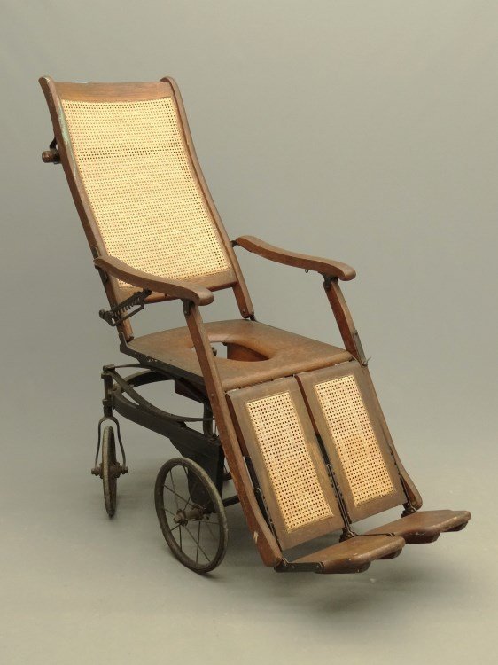 C. 1900's Invalid Chair: C. 1900's caned oak invalid chair. Comes with pillow.