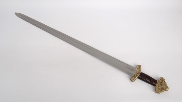 Replica Broad Sword: Replica broad sword, steel with ornate cast guard and pommel, braided leather handle. 39 1/4" L.