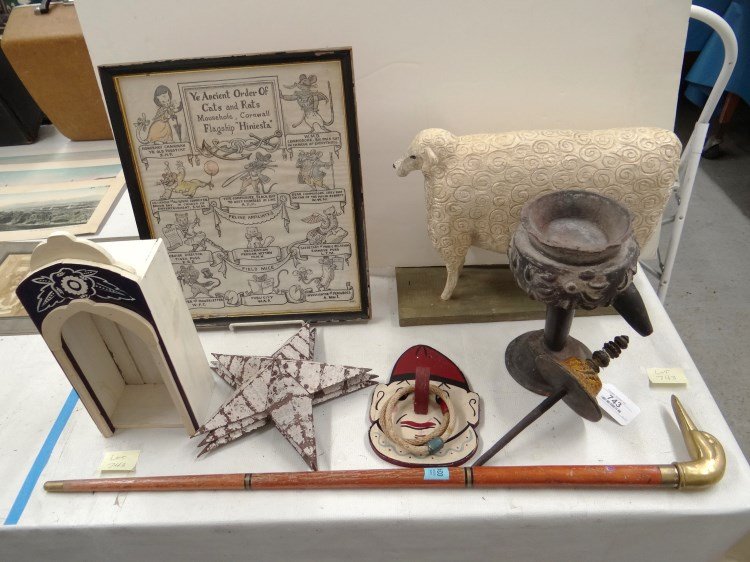 Misc. Lot: Misc. lot including: clown face ring toss, large carved wooden sheep, alter, spindle, duck head cane, framed cat cartoon, (3) tin stars, pottery chalice.