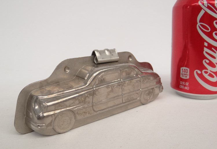 Metal Chocolate Mold: Metal chocolate mold of a car. 7" x 2 1/2" Ht..