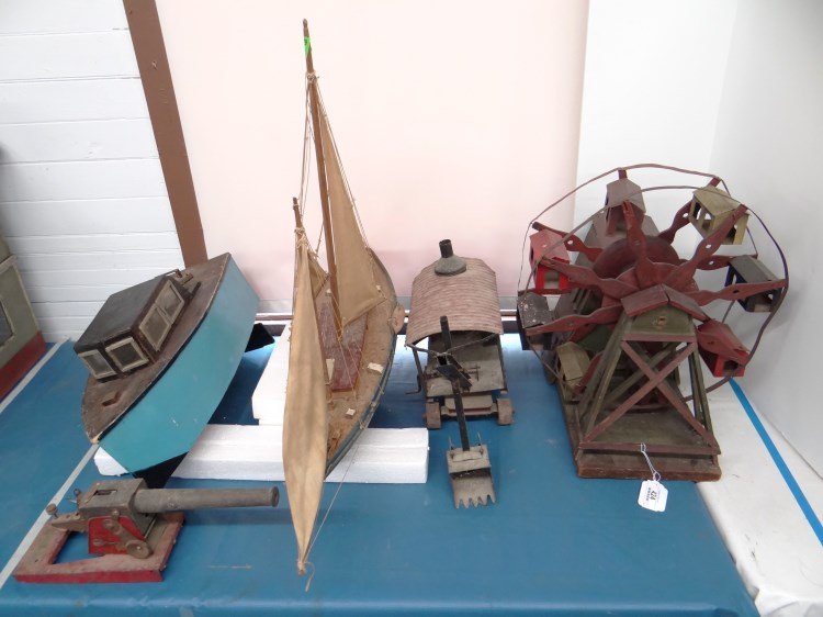 Toy Lot: Toy lot including: wooden boat, wooden sailboat, wood and tin Ferris wheel, tin steam shovel, tin cannon.