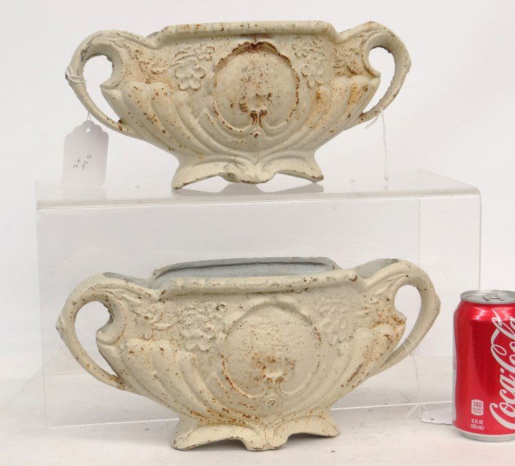 Cast Iron Urns: A pair of decorative cast iron urns in white paint. 12 1/2" x 6" Ht..