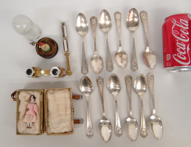 Misc. Lot: Misc. lot including 12 Oneida early screen actors spoons, MOP opera glasses (marked "C"), early wax doll in orig. case (3 1/2" Ht.), early porcelain doll in orig. case (doll 3" L.). Provenance: Redwoo